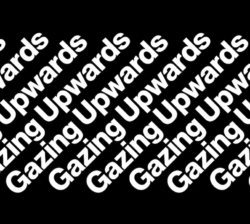 White diagonal text reading "Gazing Upwards" on a black background